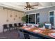 Outdoor patio with a dining table, chairs, and overhead lighting at 2923 N 81St Pl, Scottsdale, AZ 85251