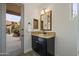 Small bathroom with granite vanity, dark cabinets, and view of the backyard at 30600 N Pima Rd # 63, Scottsdale, AZ 85266