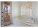 Relaxing bathroom featuring a large soaking tub and glass block window at 30600 N Pima Rd # 63, Scottsdale, AZ 85266