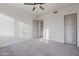 Spacious bedroom with ceiling fan and door to hallway at 30600 N Pima Rd # 63, Scottsdale, AZ 85266