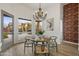 Breakfast nook with a round wooden table and chairs, offering a view of the backyard at 30600 N Pima Rd # 63, Scottsdale, AZ 85266