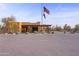 Community clubhouse with Spanish-style architecture and flagpole at 30600 N Pima Rd # 63, Scottsdale, AZ 85266