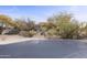 Asphalt driveway leading to a Southwestern-style home at 30600 N Pima Rd # 63, Scottsdale, AZ 85266