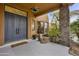 Covered entryway with double doors, tile flooring, and a stone accent wall at 30600 N Pima Rd # 63, Scottsdale, AZ 85266