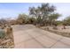 Front view of a single-story home with a large driveway and desert landscaping at 30600 N Pima Rd # 63, Scottsdale, AZ 85266