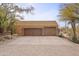 Two-car garage with wood doors and a paver driveway at 30600 N Pima Rd # 63, Scottsdale, AZ 85266