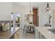 Eat-in kitchen with a brick accent wall and a chandelier at 30600 N Pima Rd # 63, Scottsdale, AZ 85266