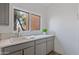 Laundry room with gray cabinets and a window at 30600 N Pima Rd # 63, Scottsdale, AZ 85266