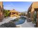 Inviting freeform pool with a desert landscape and stucco architecture at 30600 N Pima Rd # 63, Scottsdale, AZ 85266