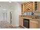 Wet bar with wine rack, granite countertop, and mini-fridge at 30600 N Pima Rd # 63, Scottsdale, AZ 85266