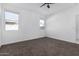 Bright bedroom with carpet, two windows, and ceiling fan at 3210 W Stradling Ave, Apache Junction, AZ 85120