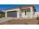 New single-story home with a two-car garage and desert landscaping at 3210 W Stradling Ave, Apache Junction, AZ 85120