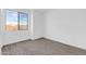 Bright bedroom with large window and wood-look tile flooring at 35810 E 138Th Pl, Scottsdale, AZ 85262