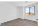 Bright bedroom with wood-look floors and large window at 35810 E 138Th Pl, Scottsdale, AZ 85262