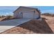 Front view of a house with a garage and desert landscape at 35810 E 138Th Pl, Scottsdale, AZ 85262