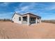 Rear view of a house with a covered patio and desert landscape at 35810 E 138Th Pl, Scottsdale, AZ 85262