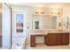 Bathroom with double vanity and a large soaking tub at 3731 E Fruitvale Ave, Gilbert, AZ 85297