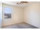 Simple bedroom with ceiling fan and large window at 3731 E Fruitvale Ave, Gilbert, AZ 85297