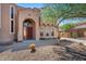 Front entrance with arched entryway and red door at 3731 E Fruitvale Ave, Gilbert, AZ 85297