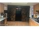 Kitchen features dark wood barn doors and black appliances at 4038 W Morrow Dr, Glendale, AZ 85308