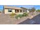 Landscaped backyard with gravel and a covered patio at 4347 W White Horse Blvd, Eloy, AZ 85131