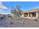 Landscaped backyard with a covered patio and fire pit at 4347 W White Horse Blvd, Eloy, AZ 85131