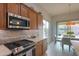 Kitchen with stainless steel appliances and wood cabinets at 4347 W White Horse Blvd, Eloy, AZ 85131