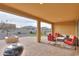 Relaxing covered patio with seating area, fire pit, and built-in grill at 4347 W White Horse Blvd, Eloy, AZ 85131