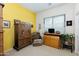 Cozy bedroom with wood cabinet, comfy chair, and yellow accent wall at 4543 E Molly Ln, Cave Creek, AZ 85331