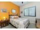 Guest bedroom with orange accent wall and window coverings at 4543 E Molly Ln, Cave Creek, AZ 85331