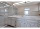 Bathroom with a shower, vanity, and marble countertop at 4902 E Flossmoor Ave, Mesa, AZ 85206