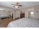 Spacious bedroom with mirrored closet doors and ceiling fan at 4902 E Flossmoor Ave, Mesa, AZ 85206