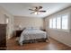 Bright bedroom with wood flooring and plantation shutters at 4902 E Flossmoor Ave, Mesa, AZ 85206