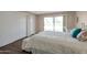 Bright bedroom with backyard view, double closets, and plush bedding at 4902 E Flossmoor Ave, Mesa, AZ 85206