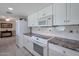 Well-equipped kitchen with white cabinets and granite countertops at 4902 E Flossmoor Ave, Mesa, AZ 85206