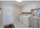 Laundry room with washer, dryer, and extra storage at 4902 E Flossmoor Ave, Mesa, AZ 85206