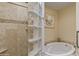 Clean bathroom with glass block shower and soaking tub at 5160 N 45Th Pl, Phoenix, AZ 85018