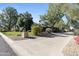 Long driveway leading to a single story home with mature landscaping at 5160 N 45Th Pl, Phoenix, AZ 85018