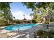 Kidney shaped swimming pool with surrounding patio furniture and umbrellas at 5160 N 45Th Pl, Phoenix, AZ 85018