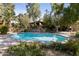 Relaxing kidney-shaped pool surrounded by landscaping in backyard at 5160 N 45Th Pl, Phoenix, AZ 85018