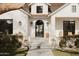 Inviting front entrance features a black arched doorway, stylish lanterns, and manicured landscaping at 5314 E Calle Del Norte --, Phoenix, AZ 85018