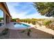 Inviting backyard oasis featuring a sparkling pool, lush landscaping, and a relaxing patio area at 5626 E Sleepy Ranch Rd, Cave Creek, AZ 85331