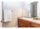 Bright bathroom featuring a wooden vanity, large mirror, and a neutral color scheme at 5626 E Sleepy Ranch Rd, Cave Creek, AZ 85331