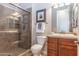 Bathroom featuring a tiled shower, a toilet, and a wood vanity with a sink and decorative mirror at 5626 E Sleepy Ranch Rd, Cave Creek, AZ 85331