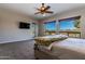 Bright bedroom with a large bed, ceiling fan, and access to backyard at 5626 E Sleepy Ranch Rd, Cave Creek, AZ 85331