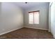 Spacious bedroom with carpet flooring and large window with blinds at 5626 E Sleepy Ranch Rd, Cave Creek, AZ 85331