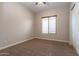 Bedroom with carpet, a window with blinds and a white door at 5626 E Sleepy Ranch Rd, Cave Creek, AZ 85331