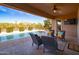 Relaxing covered patio overlooking a sparkling pool and desert landscape at 5626 E Sleepy Ranch Rd, Cave Creek, AZ 85331