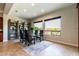 Bright dining room featuring a glass table and four chairs, built-in shelving, and large windows at 5626 E Sleepy Ranch Rd, Cave Creek, AZ 85331