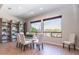 Bright dining room with a glass table, views from the large windows, and decorative shelving at 5626 E Sleepy Ranch Rd, Cave Creek, AZ 85331